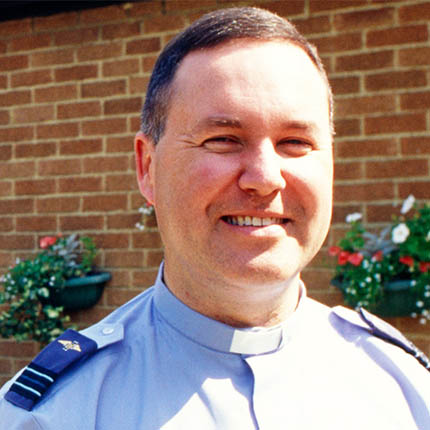 RAF Chaplain stood in front of building
