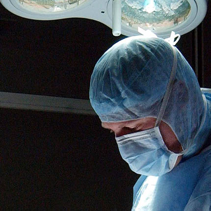 RAF Operating Department Practitioner in surgical clothing and mask assisting in operating theatre