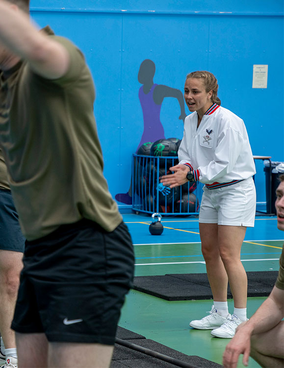 RAF Physical Training Instructor leads a circuit training session in a RAF gym.