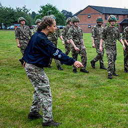 RAF Physical Training Instructor leads a Battle PT session to a course of Avionic Technicians.